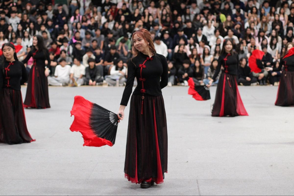 Senior Olivia Nyugen performs as a part of the Chinese Club during the first assembly for the International Food Festival on Friday, Feb. 6, in the gym. 