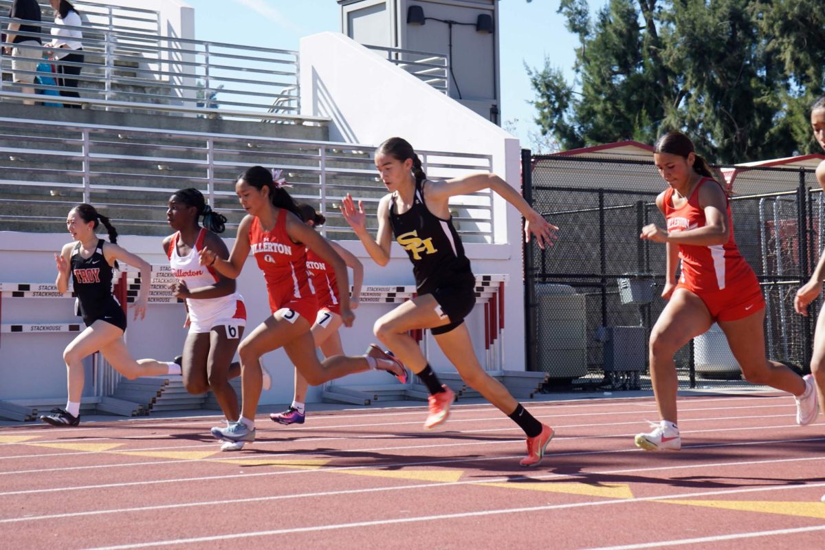 Junior Madelyn Sooter (middle) takes off for her 100-meter race during the Fullerton city meet between Fullerton High School and Troy High School on Saturday, Feb. 28. 