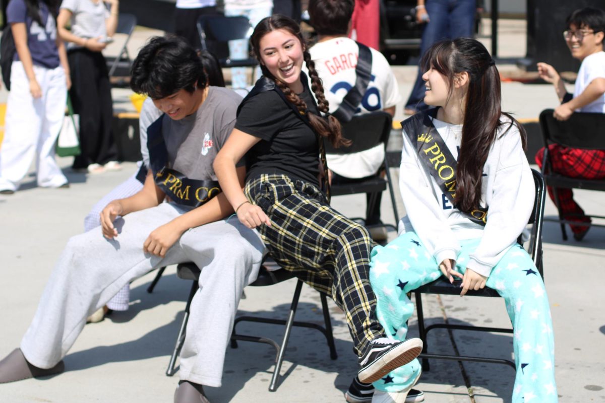 Senior Abigail Veyna (middle) competes alongside fellow prom court members in a musical chairs game Thursday, April 9, in the quad as part of prom week festivities.