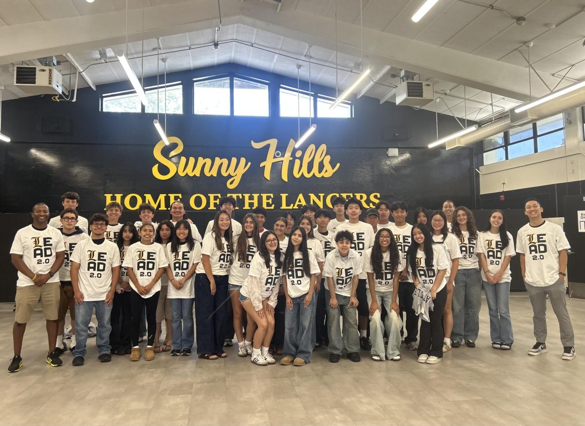 Students in the Leadership Education and Development [LEAD] program pose after learning about leadership in the cafeteria on Wednesday, April 29. This is the LEAD program’s second year.