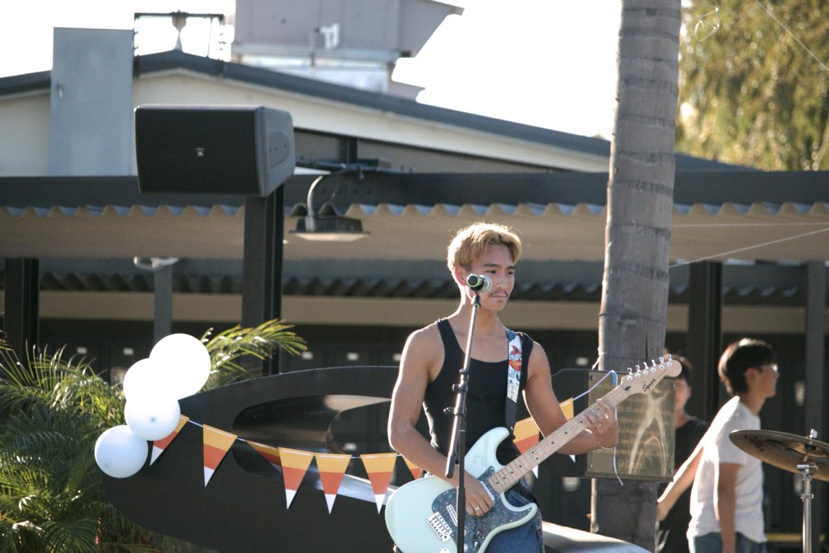 New Reputations lead singer and guitarist senior Kai Liwanag performs at the Conservatory of Fine Arts’ Fall Festival after school in the quad on Wednesday, Oct. 29.
