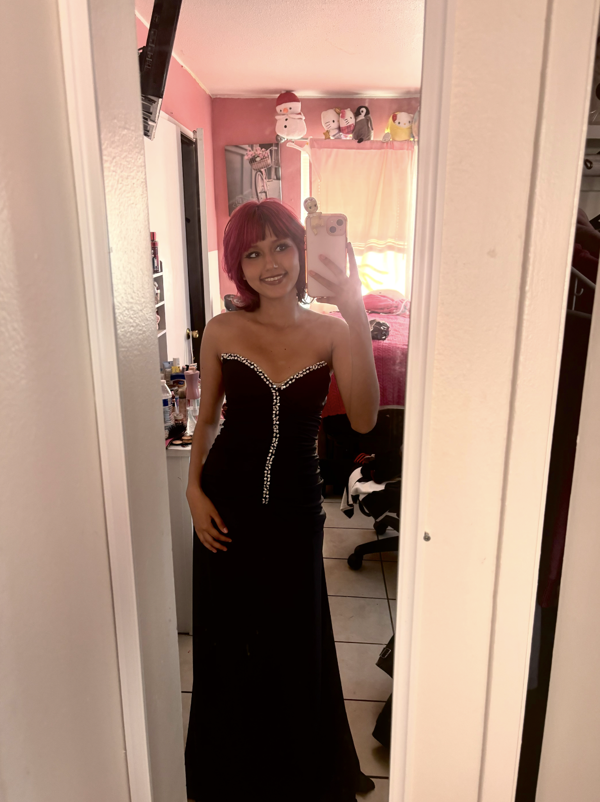 Junior Jatziry Acevedo takes a photo of herself in her prom dress at her home on Tuesday, April 7.