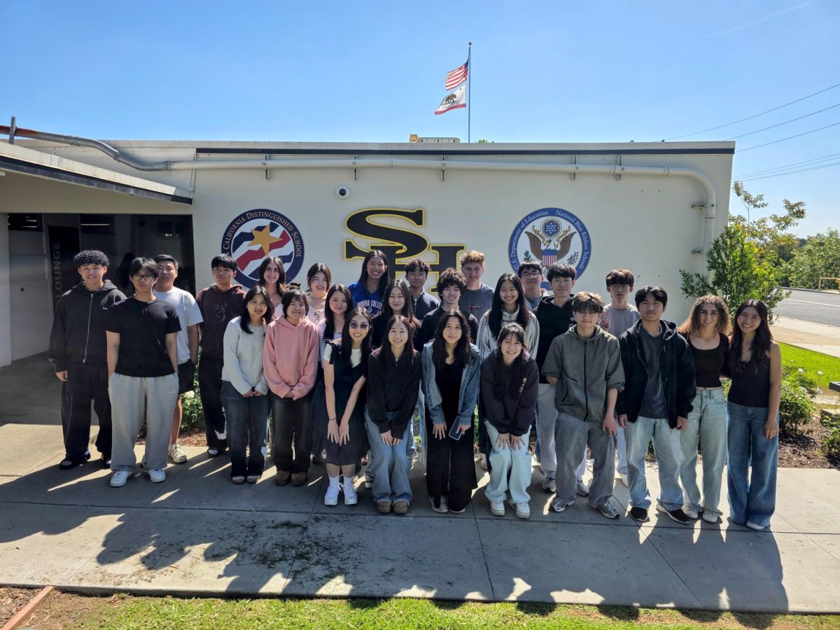 After learning they qualified as valedictorians, the 28 Class of 2026 honorees stand outside Room 2 on Wednesday, April 15, following their meeting with principal Craig Weinreich and members of the administration.